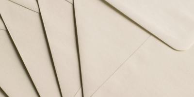 A close-up photo of beige envelopes arranged on a neutral background, ideal for stationery themes.