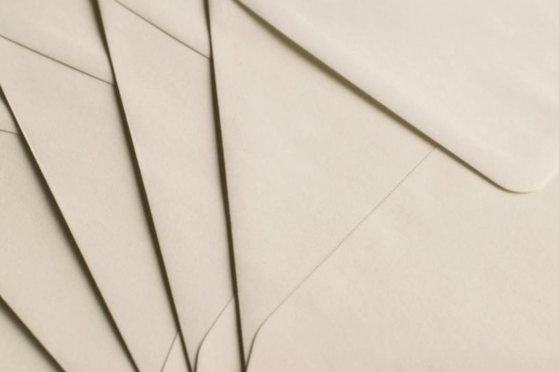 A close-up photo of beige envelopes arranged on a neutral background, ideal for stationery themes.