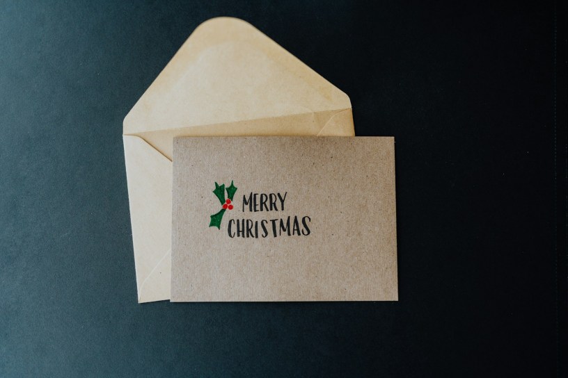 A white envelope with a merry christmas message on it